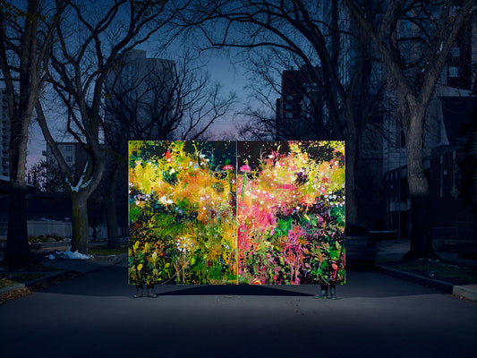 Floral explosion painting held on street at dusk by artists.