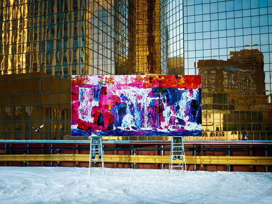 Colorful waterfall painting on snowy urban rooftop display