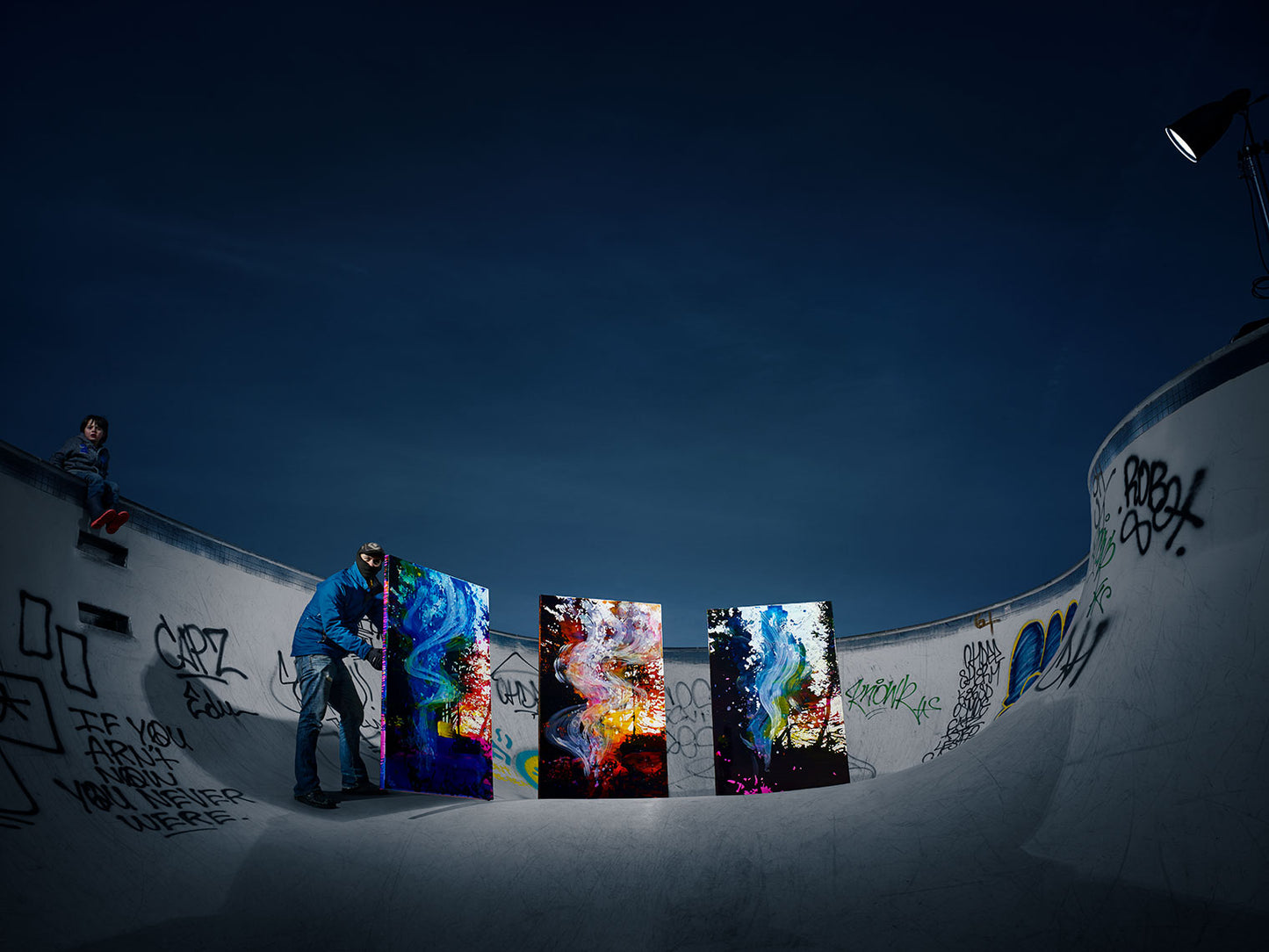 Abstract paintings installed in graffiti-covered skatepark.
