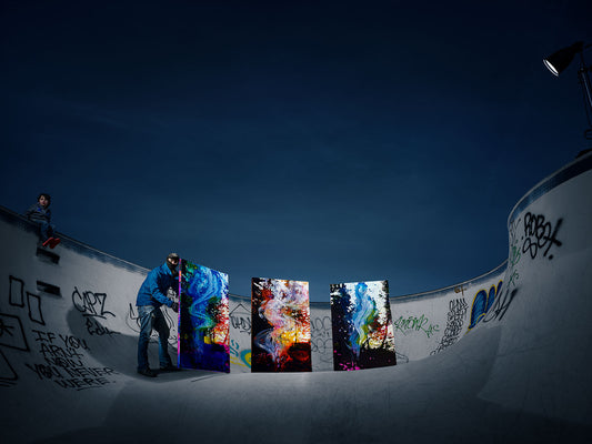 Abstract paintings installed in graffiti-covered skatepark.
