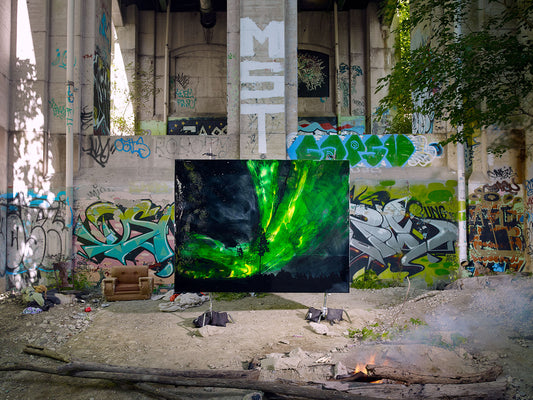 Green aurora-style painting displayed in urban graffiti zone.